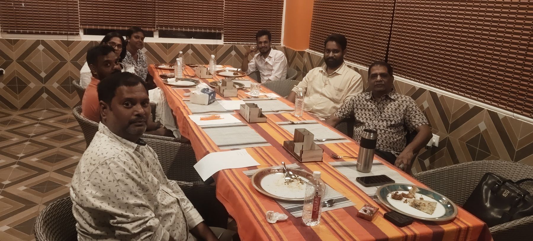 Group meeting around the long table on the top floor