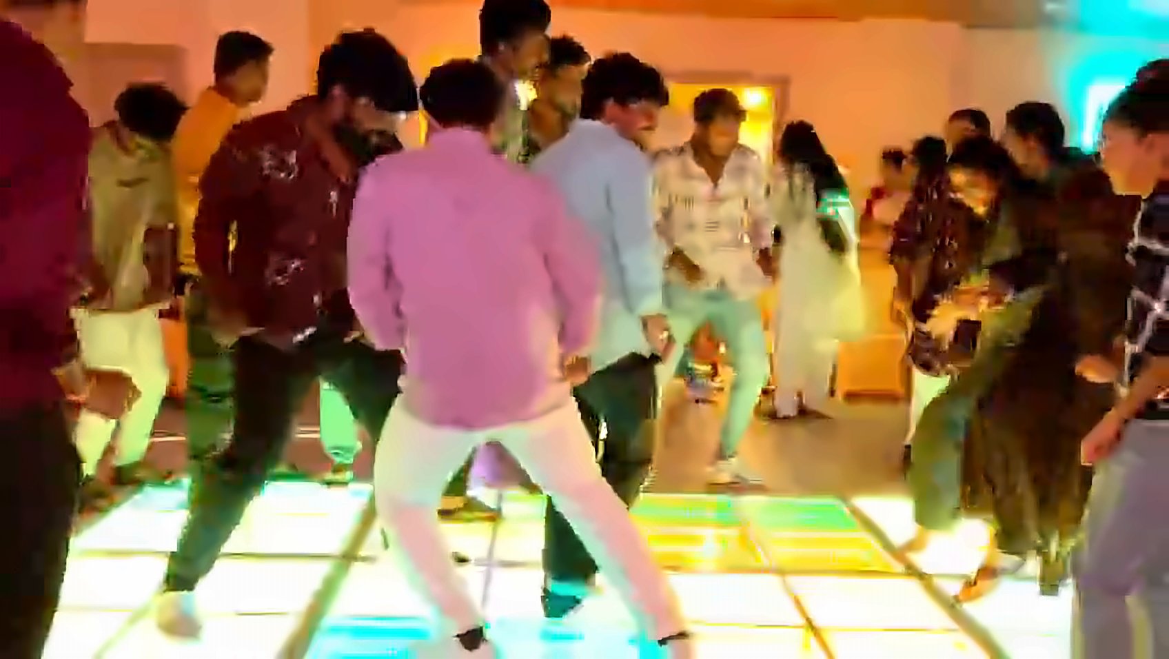 Play video: a large group dancing on the LED floor
